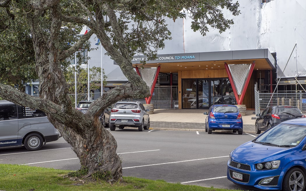 A row of pohutukawa line the banks of the Whakatāne River outside the Bay of Plenty Regional Council office in Quay Street.