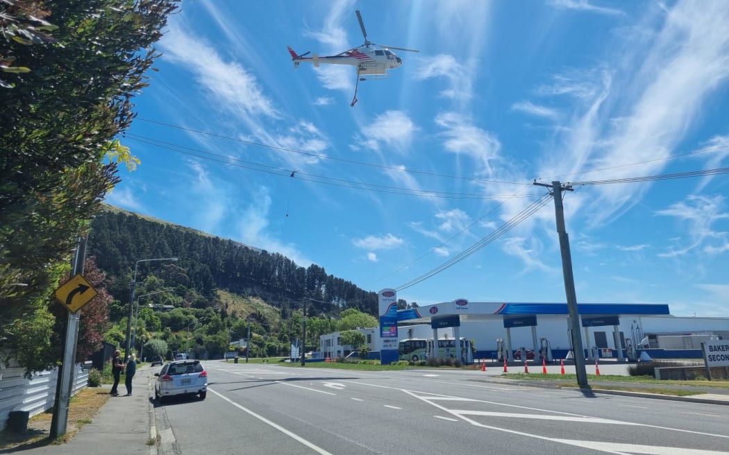A helicopter in Hillsborough involved in fighting a fire in the Port Hills on 20 November 2023.