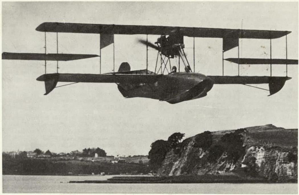 Image of the Walsh Brothers Flying School Curtiss flying boat flying above the eastern bays of Auckland