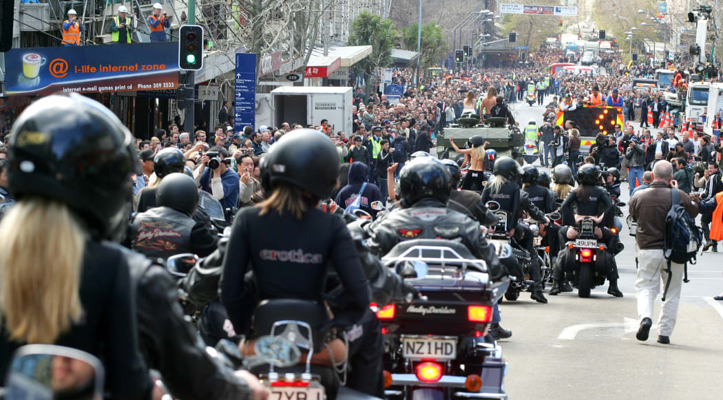 Crowds watch Boobs on Bikes' parade of topless women down Queen Street in 2006.