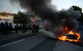 THe fIRe brigade put out a car set alight during the "Welcome to Hell" rally against the G20 summit in Hamburg, northern Germany.