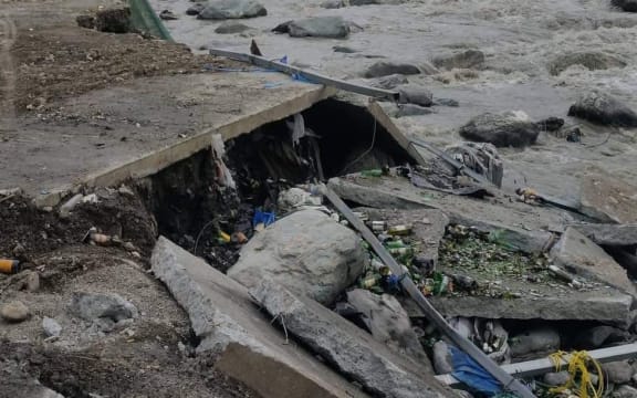 Rubbish strewn on the riverbank.