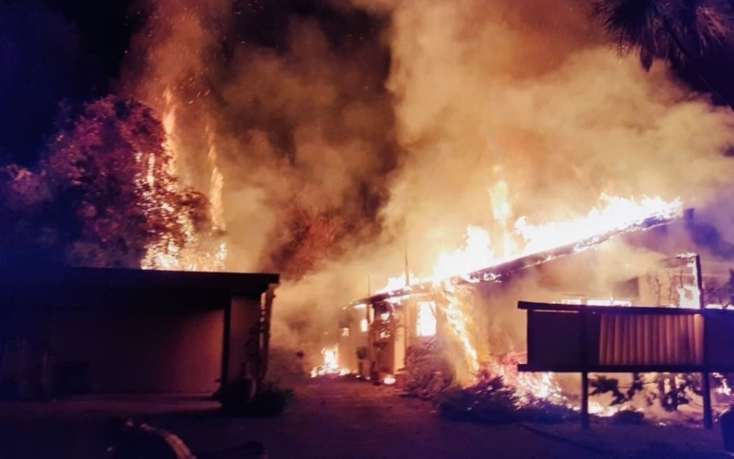 Firefighters worked to put out the fire at an abandoned house on Tahunanui Drive early this morning.