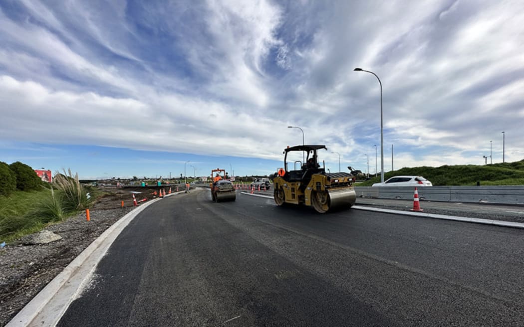 Rolling freshly placed asphalt on Truman Lane, prior to a traffic switch to restore one lane in each direction on the approach to the SH29A roundabout.