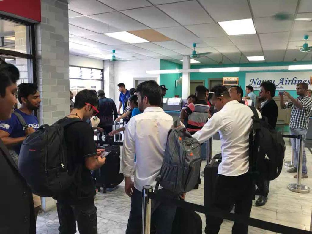 A group of refugees at the airport in Nauru.