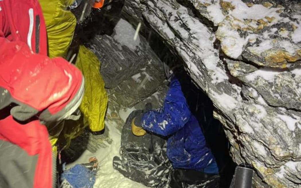 One of the climbers, in blue, is finally reached by members of the Queenstown Alpine Cliff Rescue team on The Remarkables just after 4.30am Sunday during a rescue mission which spanned more than 12 hours.