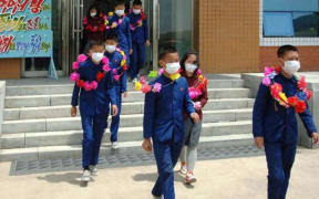 State media published photos of a ceremony for the children who allegedly volunteered.