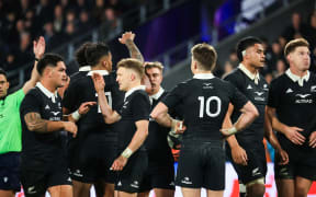 The All Blacks celebrate after beating France.