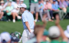 Justin Rose enjoys a birdie putt during the opening round of the Masters tournament at Augusta, Georgia. Rose holds a three-shot lead after the first round, 11 April, 2025.