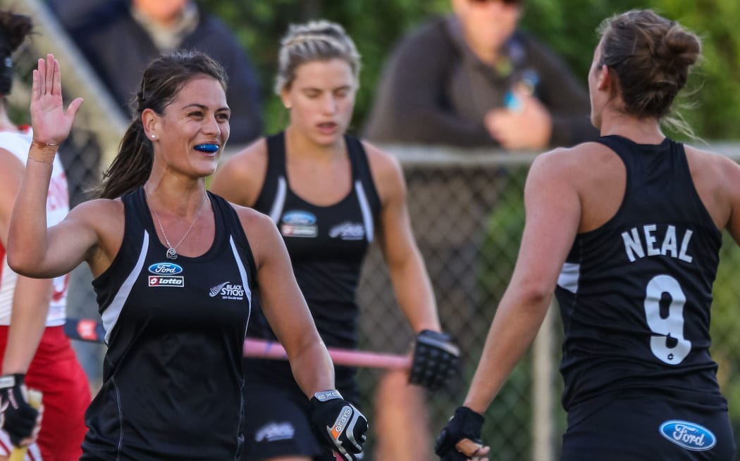 The Black Sticks women celebrate a goal.