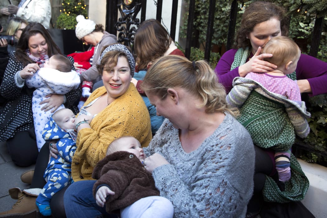 Demonstrators feed their babies during a protest in support of breastfeeding in public outside Claridge's hotel in London.