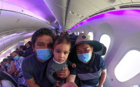 Elena and her family on the flight to Samoa