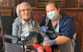 Recovered Covid-19 patient, 106-year-old Connie Titchen (left), with Sister Kelly Smith, posing for a photograph in Birmingham, central England.