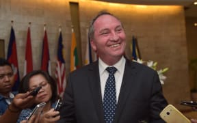 Australia's Agriculture Minister Barnaby Joyce (C) speaks to journalists in Jakarta on October 8, 2015.