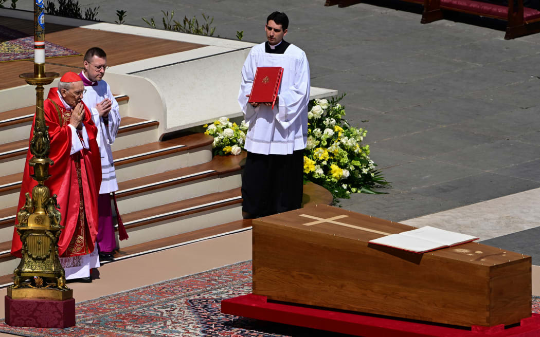 Italian cardinal Giovanni Battista Re (left) officiates the mass in front of the coffin of Pope Francis, during the funeral ceremony at St Peter's Square at the Vatican on 26 April, 2025.