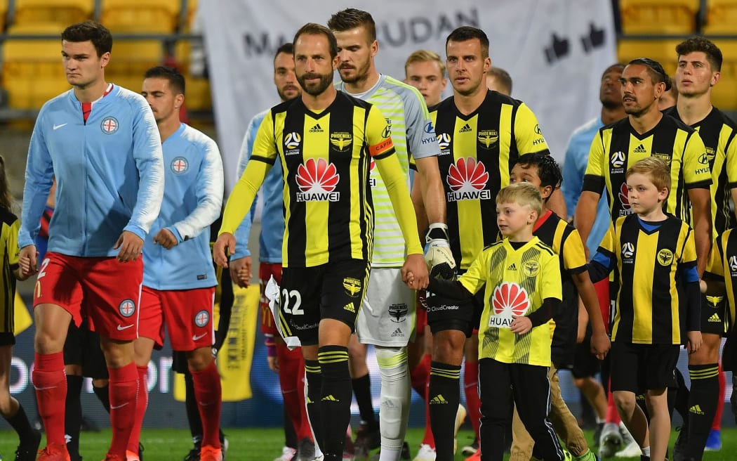 Andrew Durante leads the Phoenix onto the field against Melbourne City.