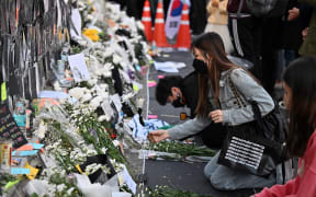 Mourners pay tributes at a makeshift memorial for the victims of the deadly Halloween crowd surge, outside a subway station in the district of Itaewon in Seoul on 1 November, 2022.