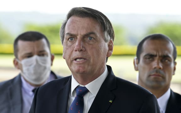 President Jair Bolsonaro (centre) maintains that Brazilians must keep working while taking precautions not to catch Covid-19.