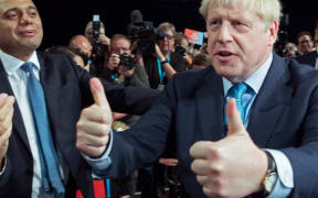 Boris Johnson acknowledges the applause from  members of his cabinet as he leaves after delivering his keynote speech on the final day of the annual Conservative Party conference.