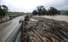 Tolaga Bay, heavy rain forced piles of wood onto farmland.