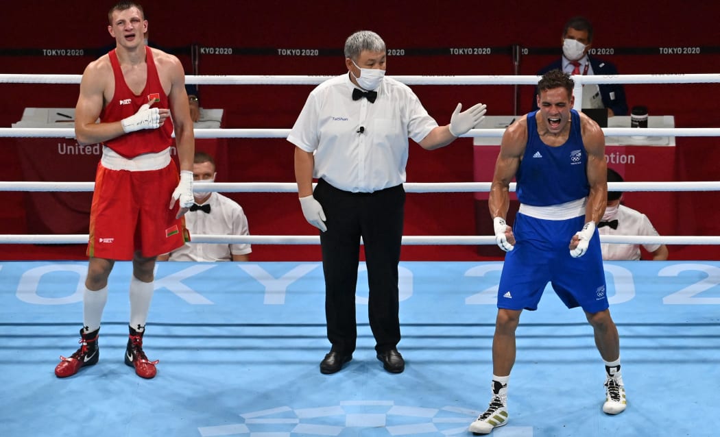 David Nyika celebrates after winning against Belarus' Uladzislau Smiahlikau.