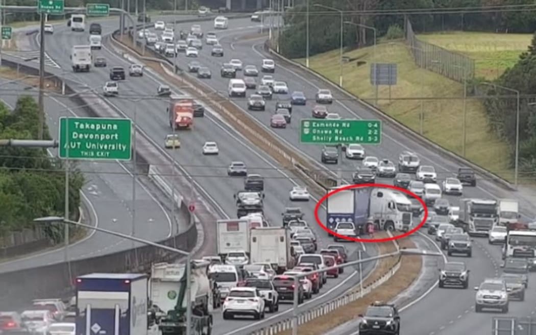 A truck crashed into the median barrier on an Auckland motorway causing traffic to back up.