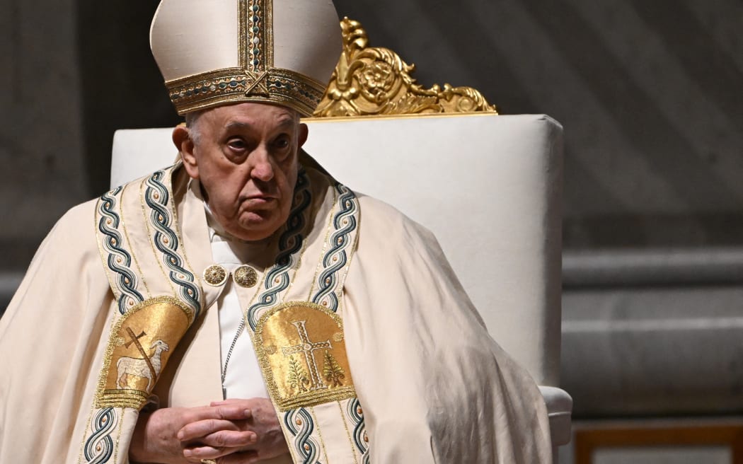 Pope Francis presides the Easter vigil as part of the Holy Week celebrations, at St Peter's Basilica in the Vatican on March 30, 2024. (Photo by Tiziana FABI / AFP)