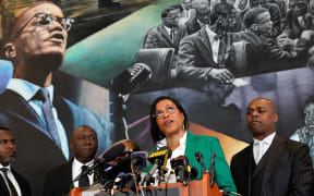 Ilyasah Shabazz (C), daughter of African-American activist Malcolm X, speaks alongside civil rights attorney Ben Crump (L) and co-counsel Ray Hamlin (R) during a press conference in New York on February 21, 2023.