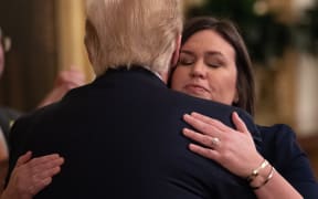 Outgoing White House Press Secretary Sarah Huckabee Sanders hugs US President Donald Trump after the announcement of her departure.