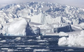 Iceberg and large fragments of drifting ice, here iceberg floating in front of the Antarctic Peninsula, climate melting global warming. Marguerite Bay, George VI Channel. Expedition below the South Polar Circle in Antarctica (Photo by Claudius Thiriet / Biosphoto / Biosphoto via AFP)