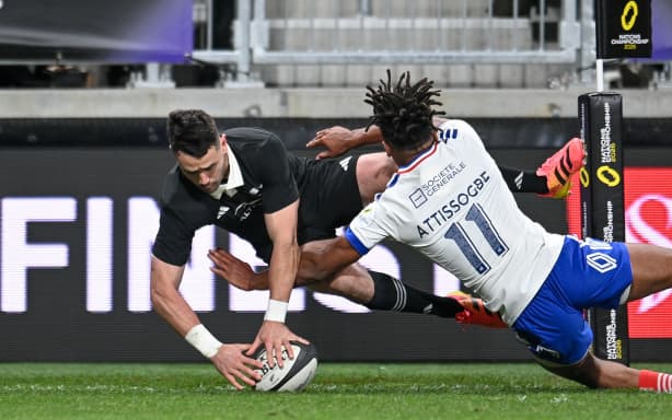Will Jordan of the All Blacks scores a try in the tackle of Theo Attissogbe of France.