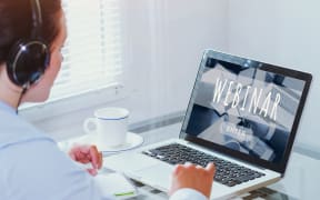 Woman watching webinar online on computer, business education concept, coaching.