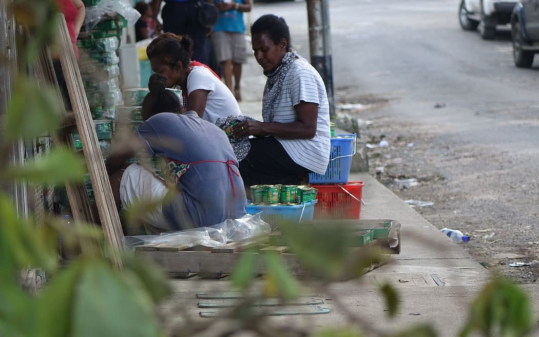 Residents of Vanuatu's capital, Port Vila, cleaning up streets after Cyclone Pam.