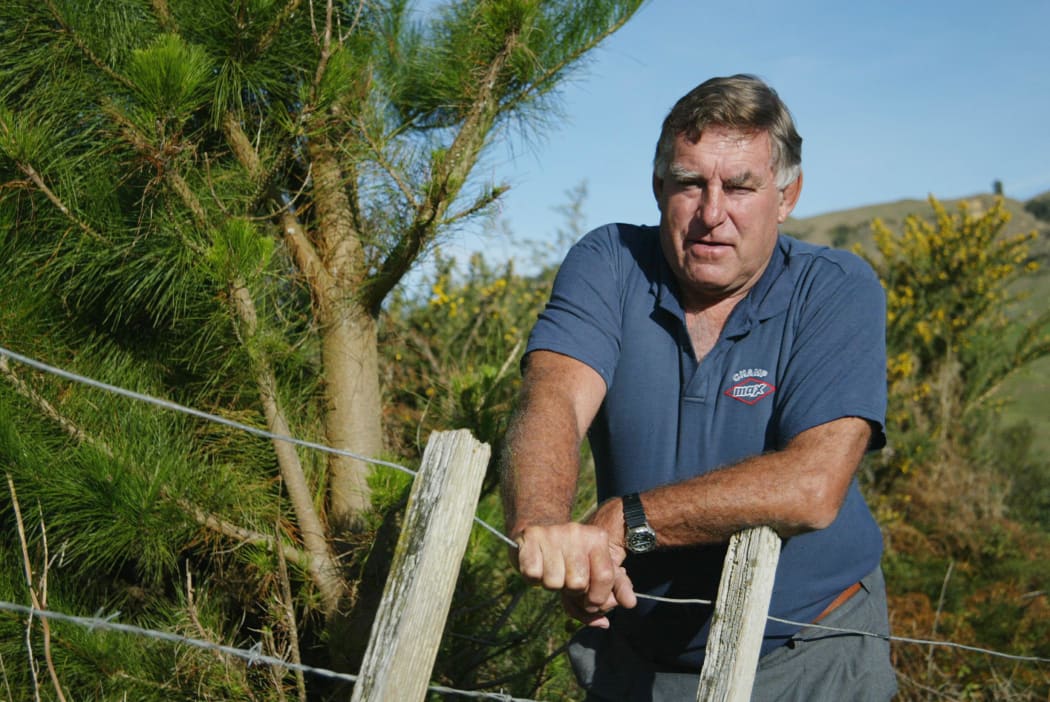 Ex-All Black Colin Meads at his farm in Te Kuiti as he stands beside the Pine Tree that grows on his property, 15 May, 2002