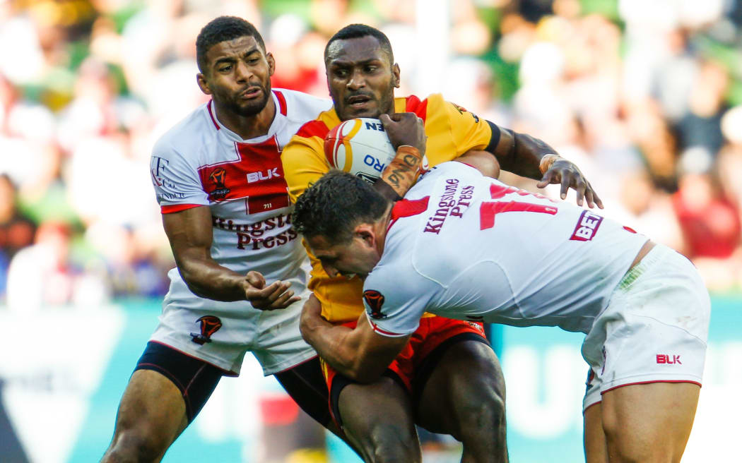 Kato Ottio gets tackled by Kallum Watkins and Sam Burgess during the England Vs Papua New Guinea 2017 Rugby League World Cup.