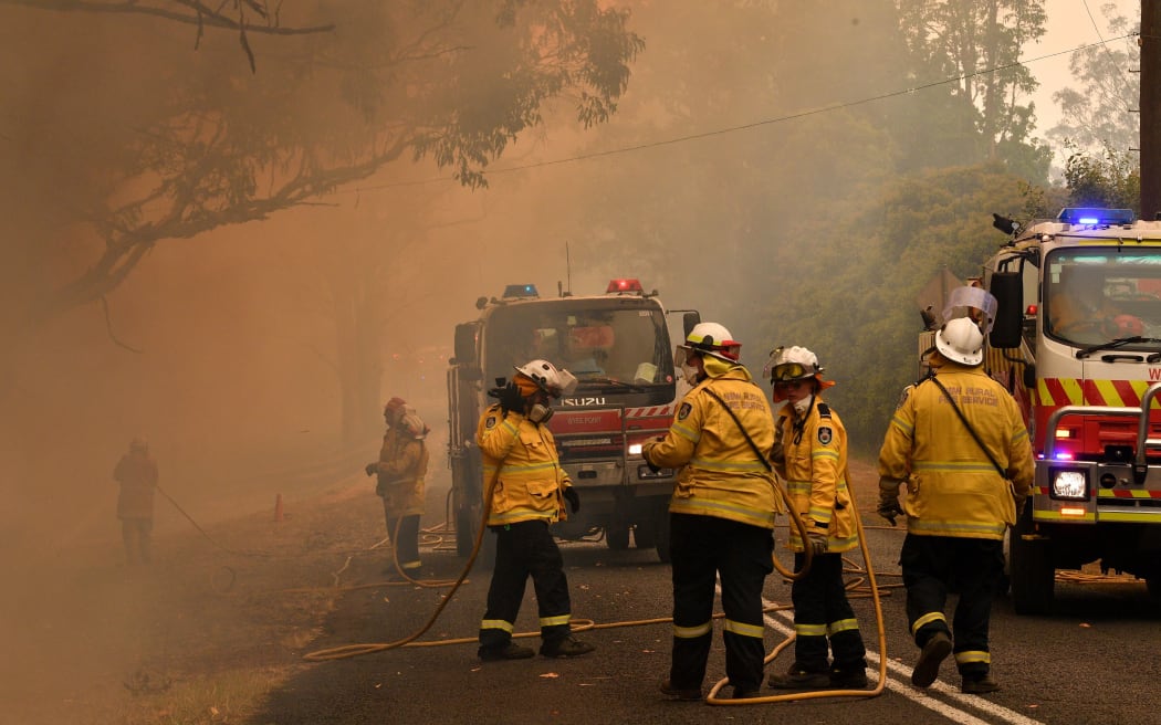 Firefighters conduct back-burning measures to secure residential areas from encroaching bushfires in the Central Coast, some 90-110 kilometres north of Sydney on December 10, 2019. -