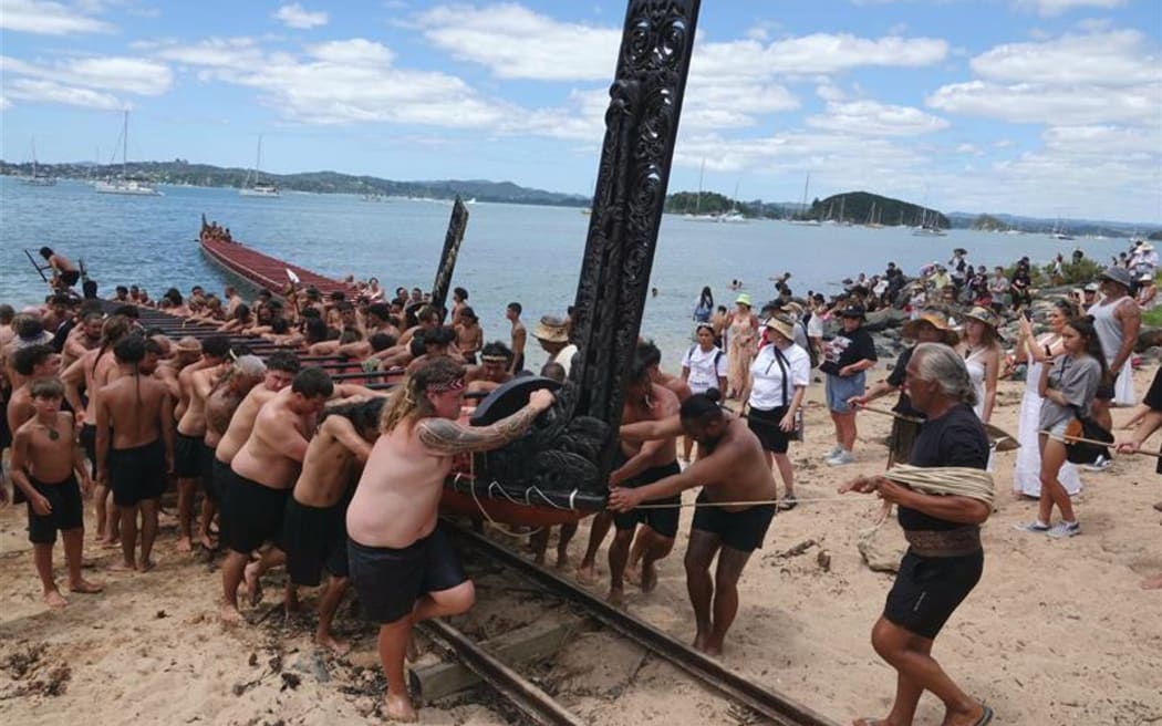 The waka Mātaatua is pulled from the water, to be returned to its whare for another year.
