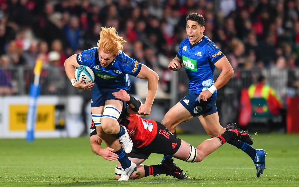 Tom Robinson of the Blues is tackled by Cullen Grace of the Crusaders during the Super Rugby Pacific match, Crusaders Vs Blues, at Orangetheory Stadium, Christchurch, New Zealand, 15th April 2022. Copyright photo: John Davidson / www.photosport.nz