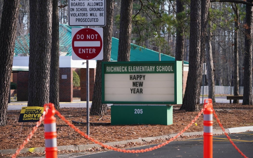 NEWPORT NEWS, VA - JANUARY 07: A school sign wishing students a "Happy New Year" is seen outside Richneck Elementary School on January 7, 2023 in Newport News, Virginia. A 6-year-old student was taken into custody after reportedly shooting a teacher during an altercation in a classroom at Richneck Elementary School on Friday. The teacher, a woman in her 30s, suffered “life-threatening” injuries and remains in critical condition, according to police reports.   Jay Paul/Getty Images/AFP (Photo by Jay Paul / GETTY IMAGES NORTH AMERICA / Getty Images via AFP)
