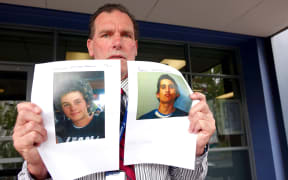 Detective Inspector Scott Beard holds photographs of the wanted teenagers.
