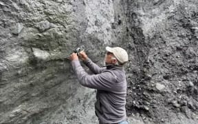 Geologist Tim Little measuring slickenlines on the Alpine Fault.