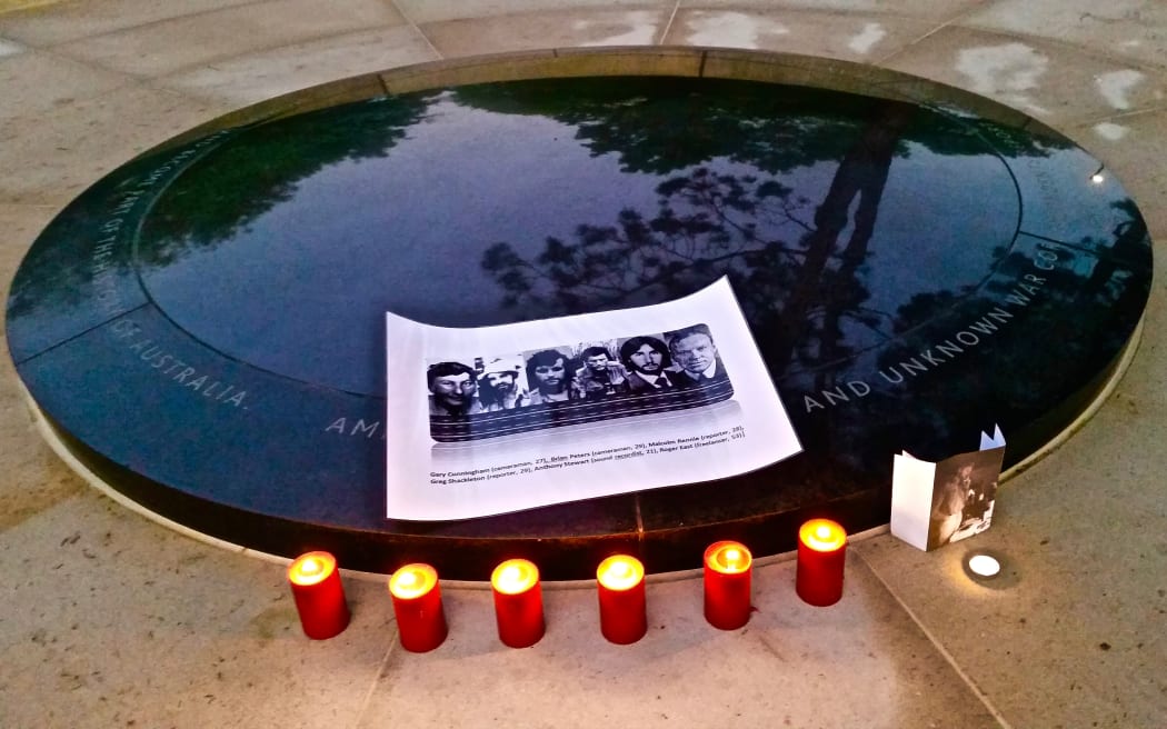 Candles burn at the War Correspondents Memorial at the Australian War Memorial to mark the 40th anniversary of the deaths of Greg Shackleton and Tony Stewart from Australia, Malcolm Rennie and Brian Peters from the United Kingdom, and Gary Cunningham from New Zealand in Balibo, Timor-Leste on 16 October 1975.
