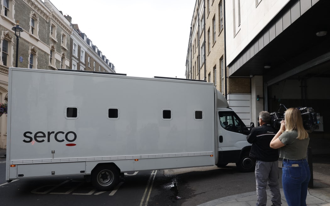 Journalists film a van believed to be transporting Jaswant Singh Chail arriving at the Westminster Magistrates' Court, in London, on August 17, 2022, in order to appear for an hearing, following his arrest while armed with a crossbow at Windsor Castle as Queen Elizabeth II spent Christmas Day there. - Police charged the 20-year-old man with an offence under Britain's 1842 Treason Act after arresting. Jaswant Singh Chail, from Southampton in southern England, has also been charged with making threats to kill and possession of an offensive weapon following the incident at the castle, southwest of London, last year. (Photo by CARLOS JASSO / AFP)