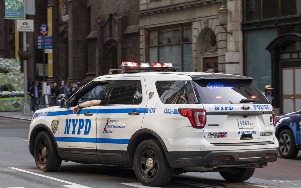 NYPD car as seen on 5th avenue near Trump Tower. Parked and moving New York City Police Department vehicles on the road are spotted moving in the traffic or parked along the street of the Fifth Ave with the NYPD logo on the side of the car and the inscription Courtesy Professionalism Respect CPR. New York City, United States of America on May 2023 (Photo by Nicolas Economou/NurPhoto) (Photo by Nicolas Economou / NurPhoto / NurPhoto via AFP)
