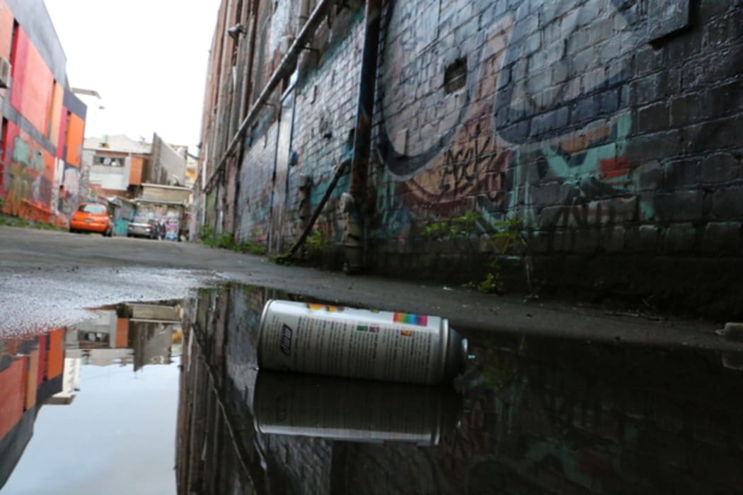 Spray paint can on the ground