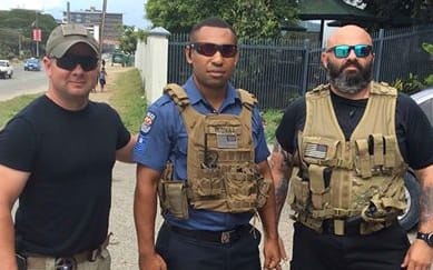 Personnel from US security firm Laurence Aviation & Security Group flank a Papua New Guinea policeman.