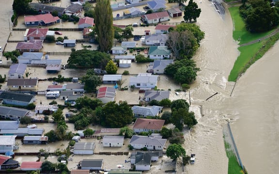Water flows into Edgecumbe through a breach in the Rangitaiki River stopbank shortly before 9am this morning.