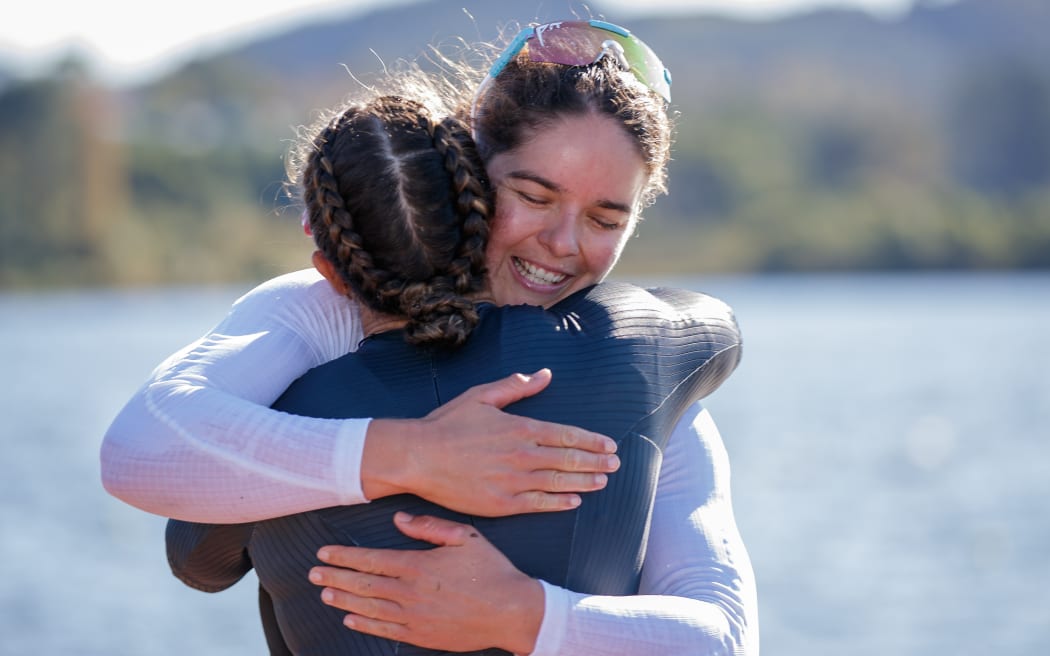 Lisa Carrington (L) and Aimee Fisher (R) embrace after the Women's K1 500m Canoe Word Championship Qualification Race 3 at Lake Karapiro in Waikato, New Zealand on Thursday April 28, 2022.