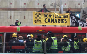 Extinction Rebellion protesters on the roof of a train at Canary Wharf, London, 25 April, 2019.
