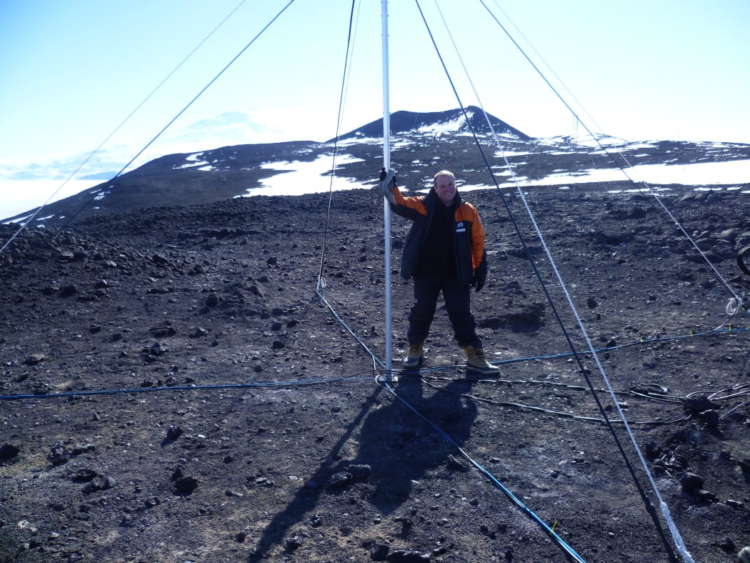 Physicist Craig Rodger standing next to the VLF radar aerial at Arrival Heights, which studies the sun by eavesdropping on messages sent to submarines (photo taken in 2010)